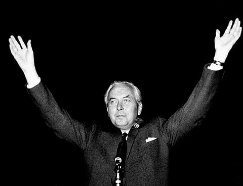 Britain's Labour Party leader Harold Wilson raises his hands after retaining his seat in the House of Commons and winning the general election.