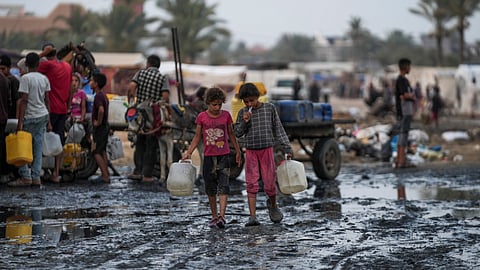 Palestinians gather to fill water jugs near one of the strip's few functioning desalination plants in Deir al-Balah, Gaza Strip.