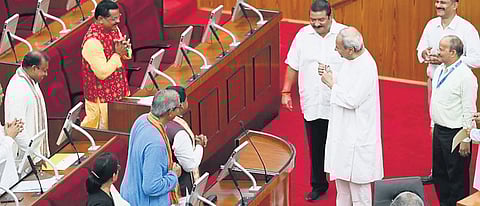 Former chief minister and Hinjili MLA Naveen Patnaik speaks to Kantabanji MLA Laxman Bag after taking oath in the Assembly on Tuesday