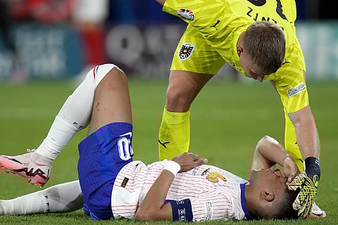 Kylian Mbappe of France receives a treatment after suffering an injury during a Group D match between Austria and France at the Euro 2024 soccer tournament in Duesseldorf, Germany, Monday, June 17, 2024.