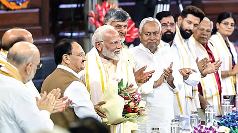BJP president JP Nadda welcomes Narendra Modi during the NDA parliamentary party meeting in New Delhi on Friday.