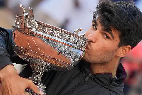 Spain’s Carlos Alcaraz rejoices with the French Open trophy in Paris on Sunday.