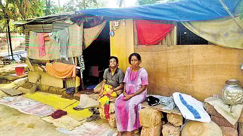 Savithri and her son in front of the shed they are currently living in.
