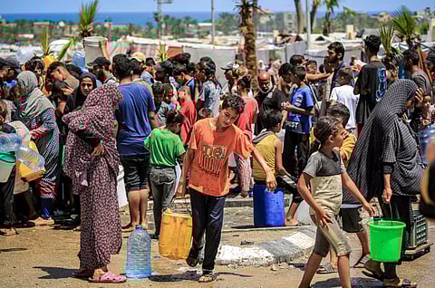 Gazans filling up water in Rafah, the southern city Israel described as Hamas's last stronghold