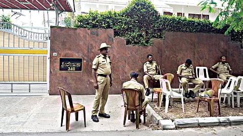 Police outside the residence of BJP leader Kumar Bangarappa following protets by the fans of actor Shivarajkumar, in Bengaluru on Saturday