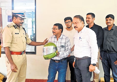 Traffic IG G Sparjan Kumar distributing a helmet to a two-wheeler rider, P K Suresh Kumar of Thampanoor, as part of the ‘Road Safety Campaign’, organised by The New Indian Express in association with Hero MotoCorp, at the IG’s office in Thiruvananthapuram on Thursday