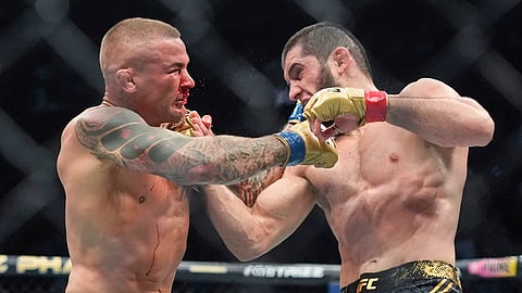 Russia's Islam Makhachev, right, punches Dustin Poirier, during the third round of a lightweight title bout at the UFC 302 mixed martial arts event early Sunday, June 2, 2024, in Newark, N.J. Makhachev won the bout.