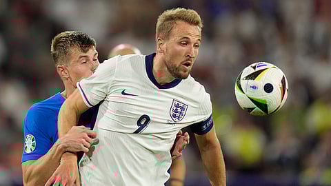 England's Harry Kane challenges for the ball with Slovenia's Jaka Bijol during a Group C match between the England and Slovenia at the Euro 2024 soccer tournament in Cologne, Germany, Tuesday, June 25, 2024.