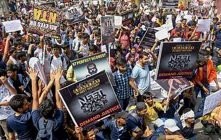 Students stage a protest demanding re-examination of NEET-UG 2024 results outside the Kashi Hindu University, in Varanasi.