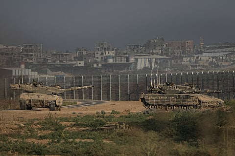 Israeli tanks stand near the Israel-Gaza border as seen from southern Israel.