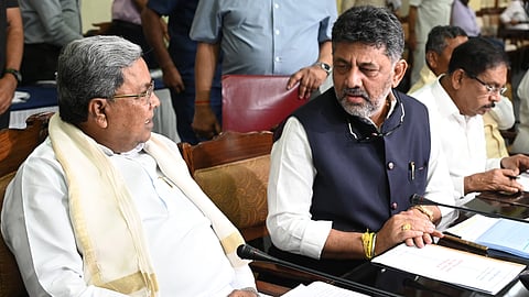 CM Siddaramaiah speaks with DCM DK Shivakumar at an all-party meeting at Vidhana Soudha in Bengaluru on Sunday.