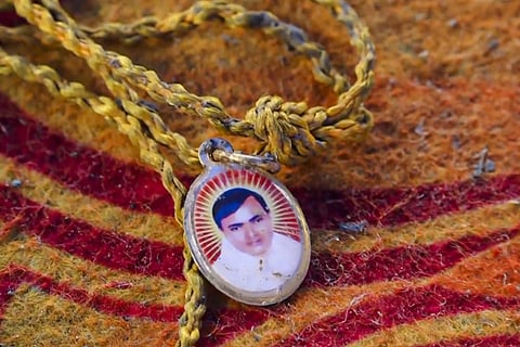 A locket depicting Suraj Pal Singh aka Bhole Baba at the spot a day after a massive stampede that took place during a 'satsang' (religious congregation)