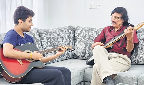 The 73-year-old VT Thomas continues to wield his guitar skillfully, teaching many students in the vicinity