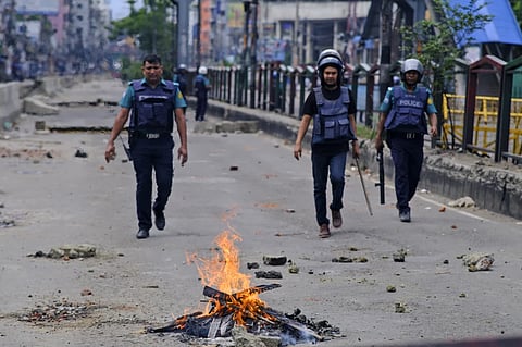 File -Police patrol the streets during an imposed curfew after scores were killed and hundreds injured in clashes over the allocation of civil service jobs, in Dhaka, Bangladesh, Sunday, July 21, 2024.