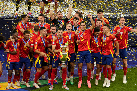 Spain's players celebrate with the trophy after winning the final match between Spain and England at the Euro 2024 soccer tournament in Berlin, Germany, Sunday, July 14, 2024.