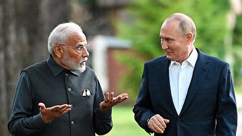 Prime Minister Narendra Modi, left, and Russian President Vladimir Putin walk during an informal meeting at Novo-Ogaryovo residence, outside Moscow in Russia.