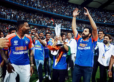 India's Kuldeep Yadav lifts the ICC T20 World Cup trophy during the celebrations of Team India's T20 World Cup 2024 victory parade, at Wankhede Stadium in Mumbai on Thursday.