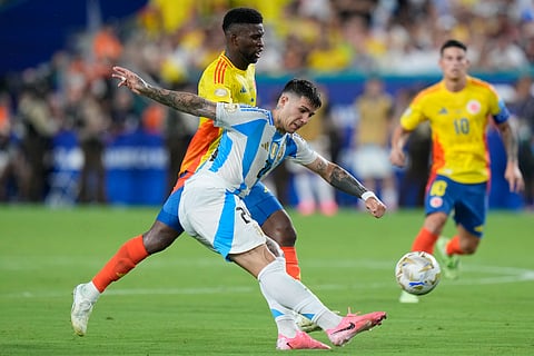 Argentina's Enzo Fernandez kicks the ball challenged by Colombia's Jefferson Lerma during the Copa America final soccer match in Miami Gardens, Fla., Sunday, July 14, 2024.