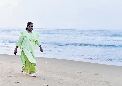 President Droupadi Murmu walks along the shore at Puri sea beach on Monday