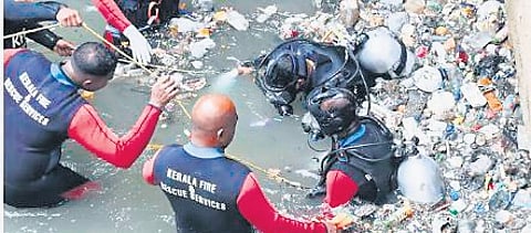Scuba divers of Fire and Rescue Services on Monday retrieve the body of Joy, the sanitation worker who had gone missing in the Amayizhanchan canal in Thiruvananthapuram
