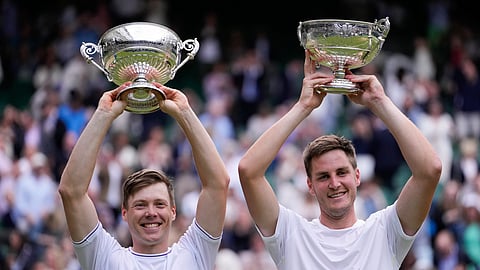 Harri Heliovaara, left, of Finland and Henry Patten of Britain hold their trophy's aloft after winning the men's doubles final at the Wimbledon on July 13, 2024.