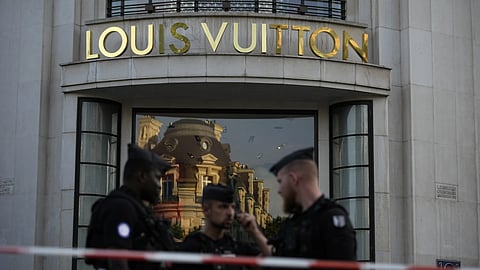 Police officers stand guard at the Louis Vuitton store on the Champs-Elysees avenue after a stabbing, Thursday, July 18, 2024 in Paris.