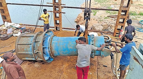 Workers dismantle motors and pipelines at Puttamgandi on Saturday morning