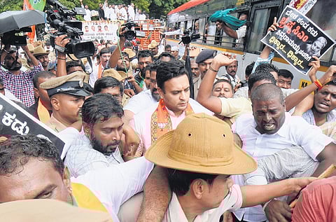Police detain BJP MP Yaduveer Krishnadatta Chamaraja Wadiyar and party workers as they try to lay seige to MUDA office in Mysuru on Friday