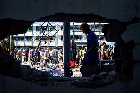 Palestinians check the destruction at the UN-run Al-Razi School in the Nuseirat refugee camp after an Israeli strike on July 16, 2024, amid the ongoing conflict in the Palestinian territory between Israel and Hamas.