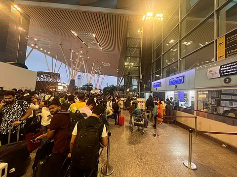 Flyers queue up outside Indigo counter in T1 to claim refunds.