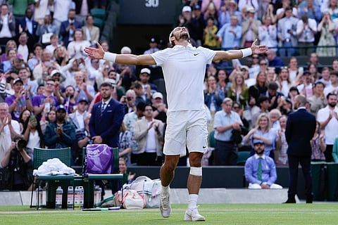Lorenzo Musetti of Italy celebrates after defeating Taylor Fritz of the United States in their quarterfinal match at the Wimbledon tennis championships in London, Wednesday, July 10, 2024.