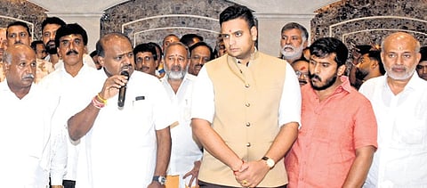 Minister H D Kumaraswamy speaks at a party workers’ meet in Mysuru on Sunday