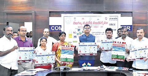 VMC Commissioner Swapnil Dinakar Pundkar unveils dengue and malaria prevention posters.