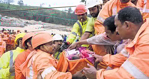 An infant being rescued by the National Disaster Relief Force (NDRF) team from the landslide-affected Mundakkai in Wayanad on Tuesday