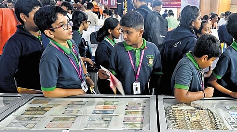 Visitors at Nanya Darshini-2024, an exhibition of rare coins and currencies organised by Karnataka Numismatic Society, in Bengaluru on Friday