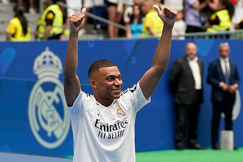 Kylian Mbappe, of France, gestures as he is presented to fans as a new Real Madrid player at the Santiago Bernabeu stadium in Madrid