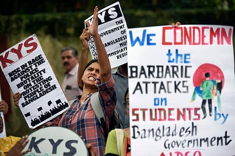 Activists of All India Democratic Students' Organisation (AIDSO) shout slogans in solidarity with protesting students in Bangladesh, at a protest gathering in New Delhi.