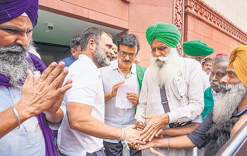 Leader of Opposition in Lok Sabha Rahul Gandhi being greeted by farmers during the monsoon session of Parliament in New Delhi on Wednesday.