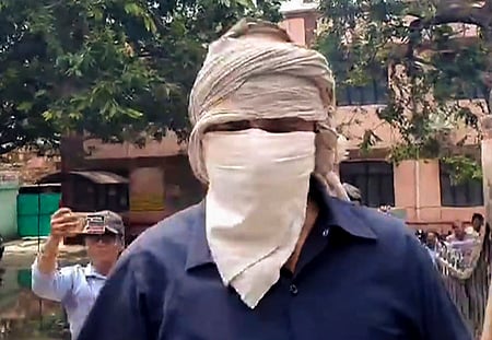 Prime accused in the Hathras stampede case, Devprakash Madhukar, being brought by the police to a hospital.
