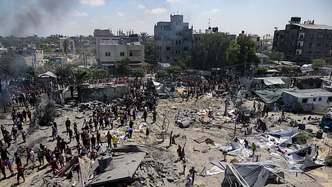 Palestinians inspect the damage at a site hit by an Israeli bombardment on Khan Younis, southern Gaza Strip, Saturday, July 13, 2024.