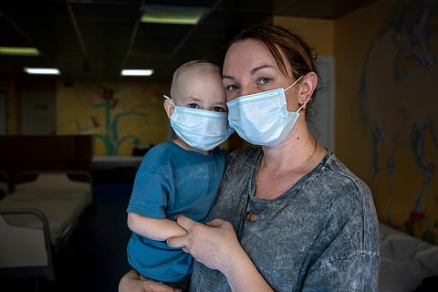 Oksana Halak poses for a portrait with her son Dmytro, 2, at the National Cancer Institute in Kyiv, Ukraine