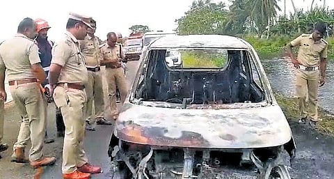 Police inspect the car that caught fire at Vengal in Tiruvalla