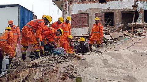 NDRF personnel during a rescue operation after a multi-storey building collapsed, in Deoghar district.