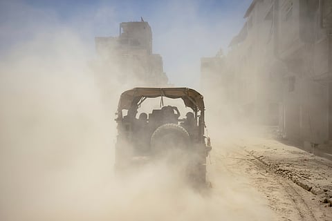 Israeli army vehicles transport a group of soldiers and journalists inside the southern Gaza Strip, Wednesday, July 3, 2024.