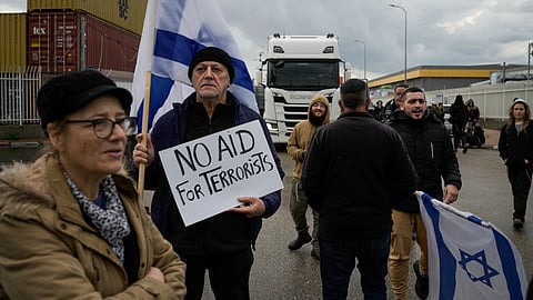 Israeli activists block the exit of Ashdod port to stop trucks they claim are carrying humanitarian aid destined for the Gaza Strip, in Ashdod, Israel, Thursday, Feb. 1, 2024.