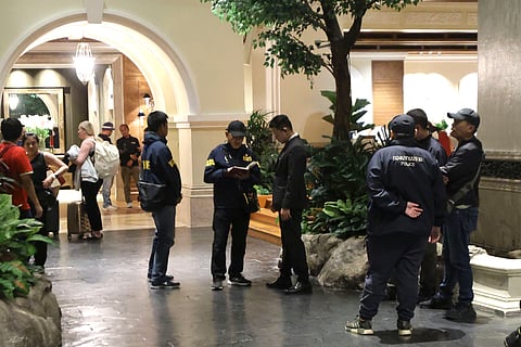 Police officers talk to a staff member at the Grand Hyatt Erawan Hotel in Bangkok, Thailand, Tuesday, July 16, 2024.
