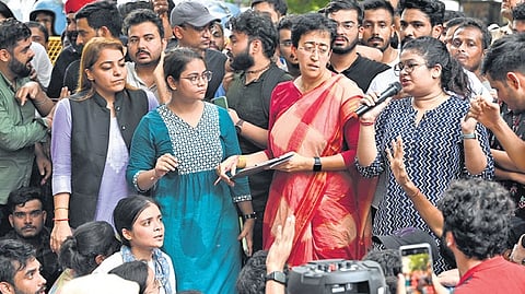 Delhi Minister Atishi with protesting students at Old Rajinder Nagar