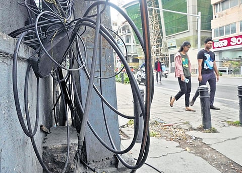 Power cables bundled up on a wall on Cunningham Road