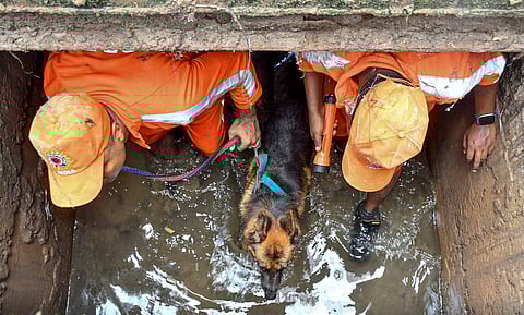 NDRF and SDRF personnel conduct a search operation for an 8-yeay-old boy who was washed away by floodwater, at Jyotinagar area in Guwahati, Saturday, July 6, 2024.