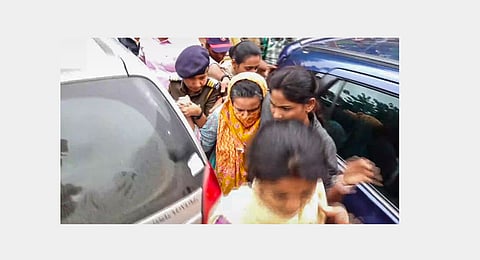 Manorama Khedkar, mother of IAS probationer Puja Khedkar, being brought by the police to a hospital for medical examination after her arrest in a case of allegedly threatening some persons by brandishing a gun over a land dispute, in Pune district, Thursday, July 18, 2024.